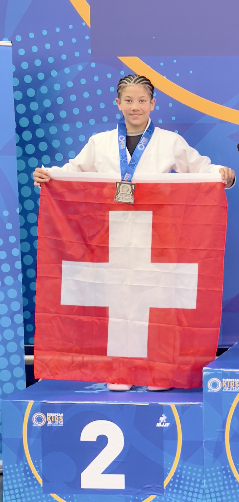 Zweiter Platz an der European Kids IBJJF Championship 2026 in Dublin, auf dem Podest mit der Schweizer Fahne.